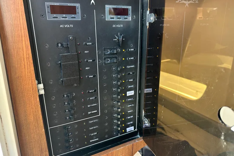 Slide: The Image of Electrical panel on Invincible 42 boat, 2018 model, showing AC and DC volt meters. - 11