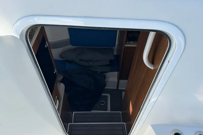 Slide: The Image of Interior cabin view of 2018 Invincible 42 boat, featuring wooden accents and seating. - 19