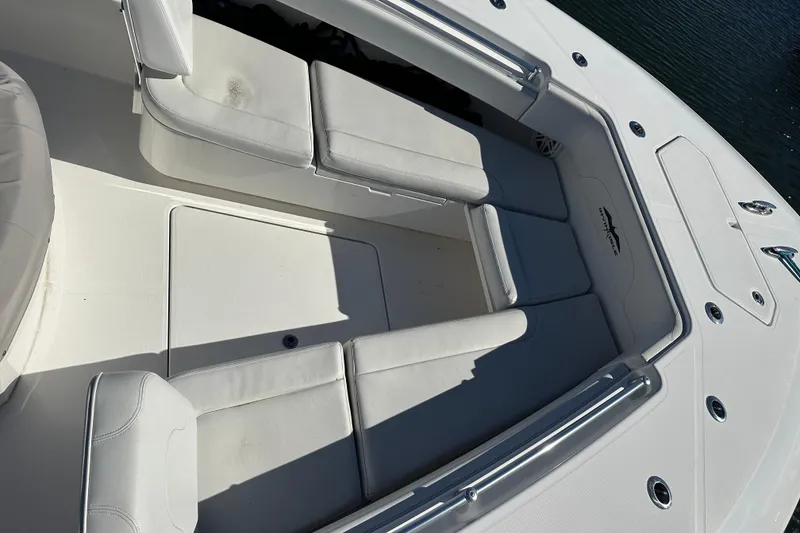 Slide: The Image of 2018 Invincible 42 boat interior with white cushioned seating and sleek design. - 4