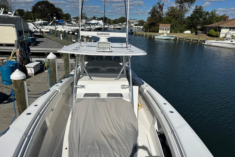 Slide: The Image of Invincible 42 boat docked at marina, featuring Garmin equipment, 2018 model. - 5