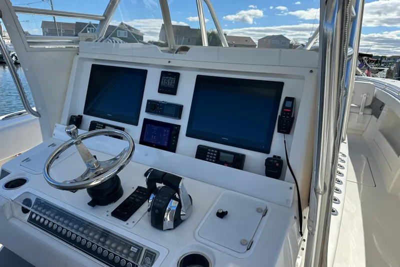Slide: The Image of Control panel of a 2018 Invincible 42 boat with navigation screens and steering wheel. - 7