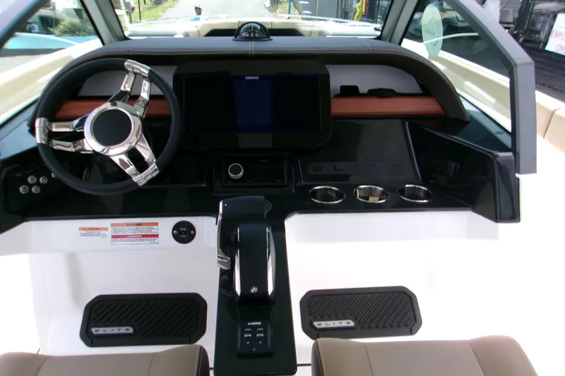 Slide: The Image of 2026 Monterey Elite 27 OB boat dashboard with modern steering and control panel. - 11