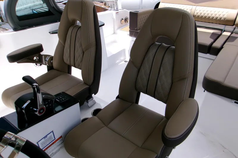 Slide: The Image of Luxurious seating in 2026 Monterey Elite 27 OB boat interior, featuring premium upholstery and controls. - 13