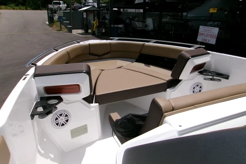 Slide: The Image of 2026 Monterey Elite 27 OB boat interior with tan seating and cup holders. - 14