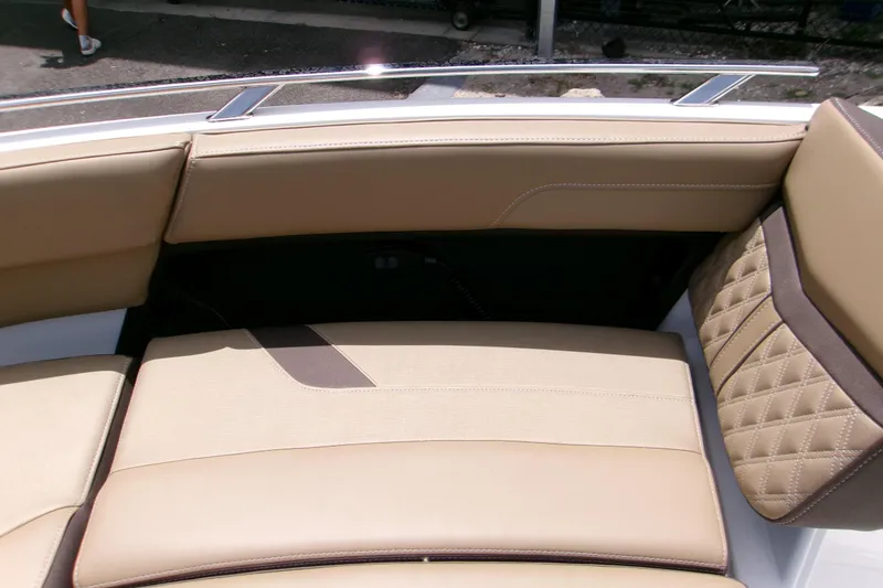 Slide: The Image of 2026 Monterey Elite 27 OB boat interior with beige leather seating and quilted design. - 15