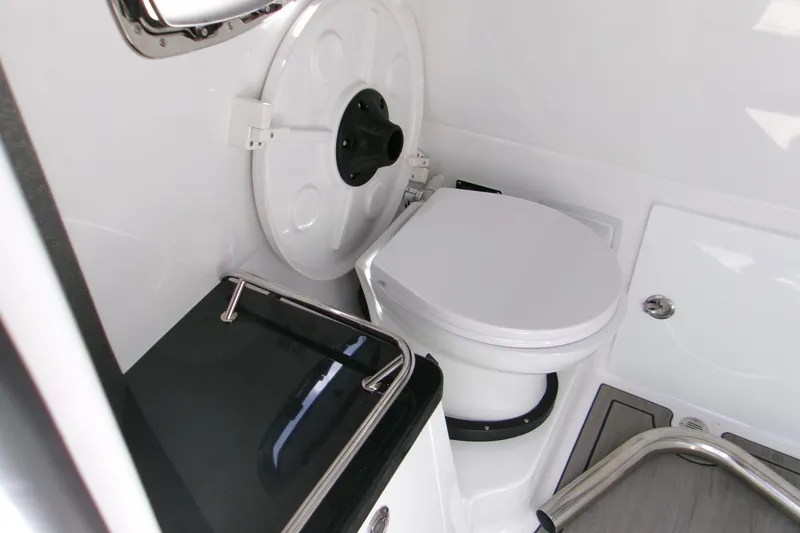 Slide: The Image of 2026 Monterey Elite 27 OB boat bathroom with modern toilet and sleek design. - 17