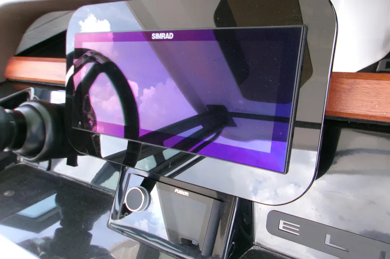 Slide: The Image of Dashboard of 2026 Monterey Elite 27 OB with Simrad display and Fusion controls. - 18