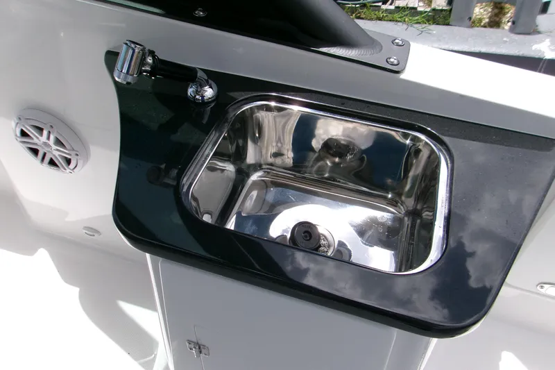 Slide: The Image of Stainless steel sink on 2026 Monterey Elite 27 OB boat with sleek black countertop. - 5