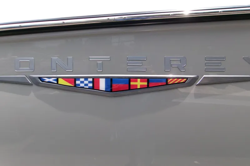 Slide: The Image of Monterey Elite 27 OB 2026 boat emblem with nautical flags on gray background. - 7