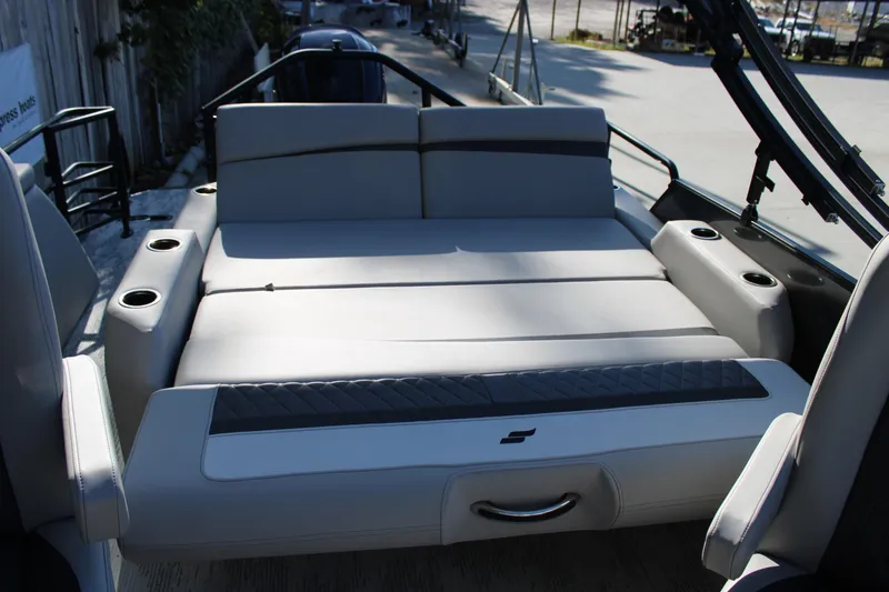 Slide: The Image of 2026 Starcraft SLS 3 Q DH boat interior with cushioned seating and cup holders. - 10