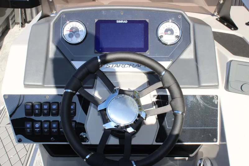 Slide: The Image of 2026 Starcraft SLS 3 Q DH boat dashboard with steering wheel and control panel. - 12