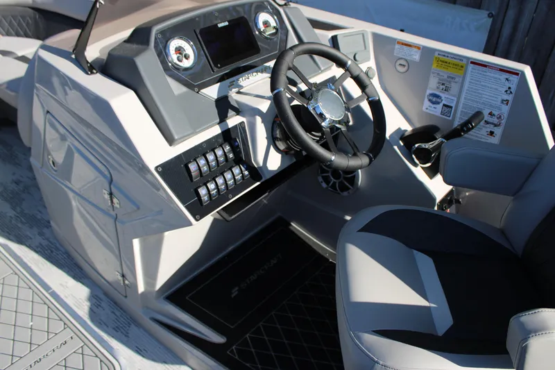 Slide: The Image of 2026 Starcraft SLS 3 Q DH boat dashboard with steering wheel and control panel. - 16