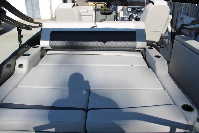 Slide: The Image of 2026 Starcraft SLS 3 Q DH boat interior with luxurious seating and cup holders. - 7
