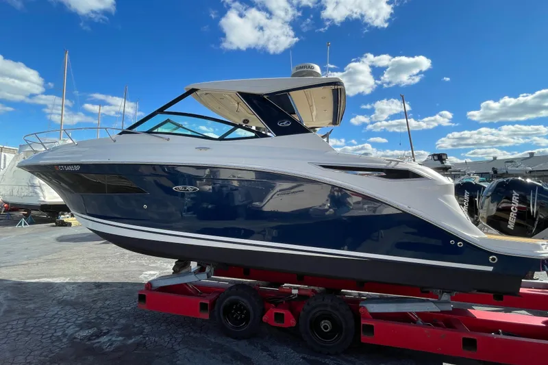 The Image of 2020 Sea Ray Sundancer 320 boat on trailer under a clear blue sky. - 0