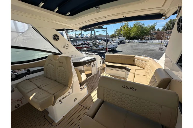 Slide: The Image of 2020 Sea Ray Sundancer 320 interior with beige seating and modern design. - 12