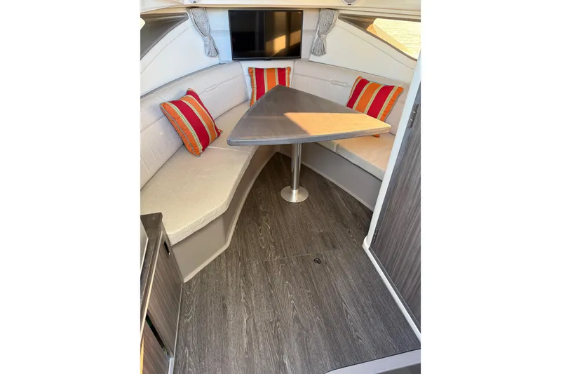 Slide: The Image of 2020 Sea Ray Sundancer 320 cabin interior with cozy seating and vibrant cushions. - 19