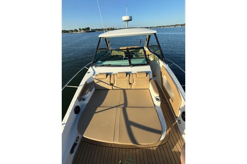 Slide: The Image of 2020 Sea Ray Sundancer 320 boat with spacious deck, cruising on calm waters. - 20