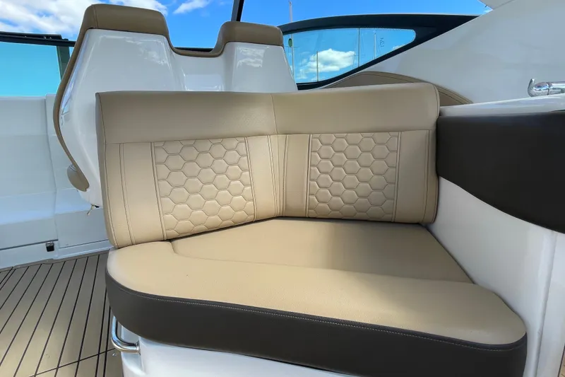Slide: The Image of Luxurious seating on 2020 Sea Ray Sundancer 320 boat with beige upholstery and hexagonal pattern. - 26