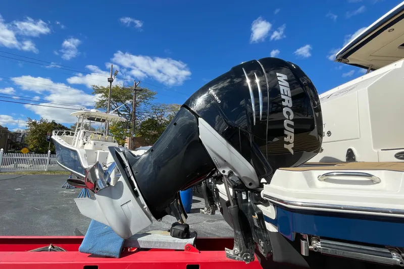 Slide: The Image of 2020 Sea Ray Sundancer 320 with Mercury outboard motor under clear blue sky. - 27