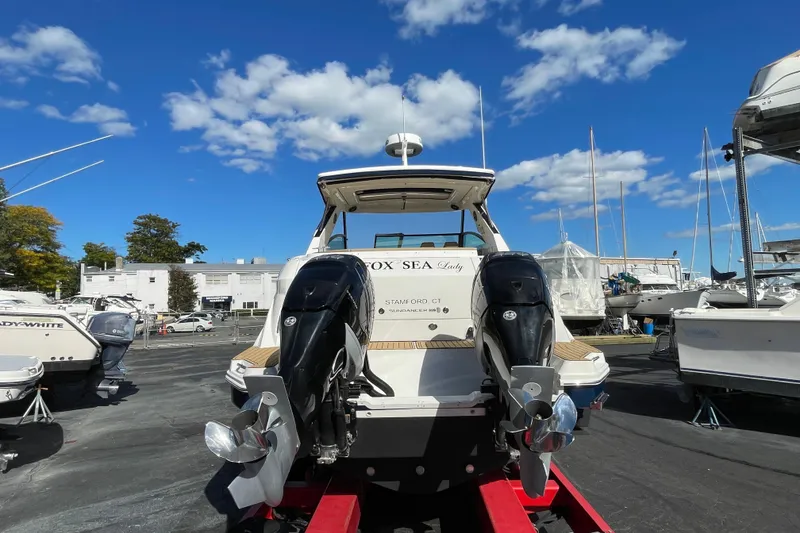 Slide: The Image of 2020 Sea Ray Sundancer 320 boat with dual outboard motors on a sunny day. - 28