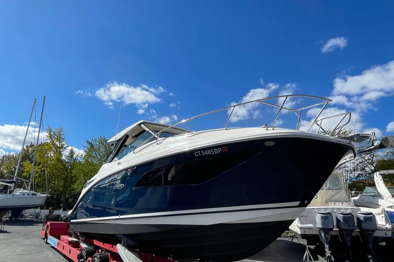 Slide: The Image of 2020 Sea Ray Sundancer 320 boat on trailer under clear blue sky. - 3