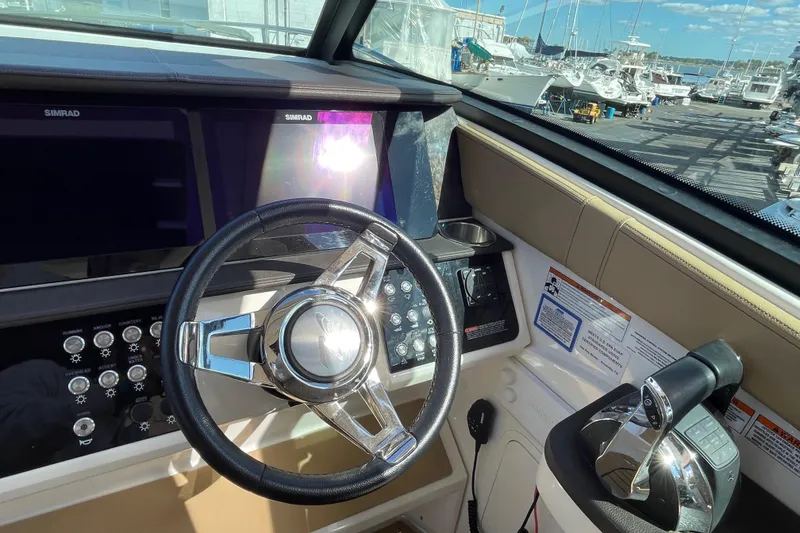 Slide: The Image of 2020 Sea Ray Sundancer 320 helm with steering wheel and control panel. - 39
