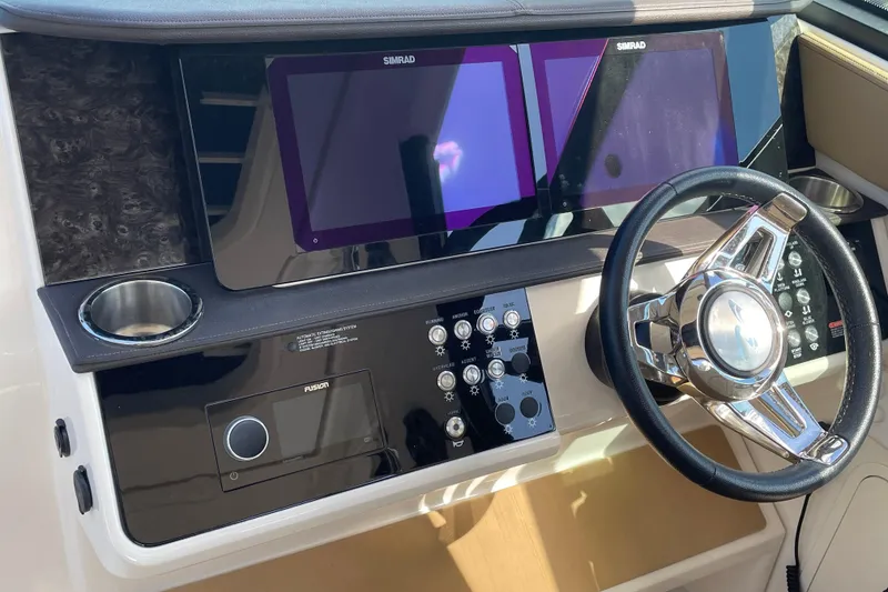 Slide: The Image of 2020 Sea Ray Sundancer 320 helm with dual Simrad displays and modern controls. - 40