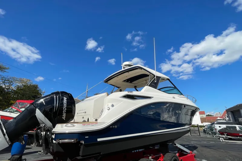 Slide: The Image of 2020 Sea Ray Sundancer 320 boat on display under a clear blue sky. - 43