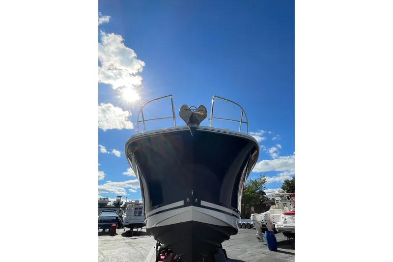 Slide: The Image of 2020 Sea Ray Sundancer 320 boat under bright blue sky with sun and clouds. - 44