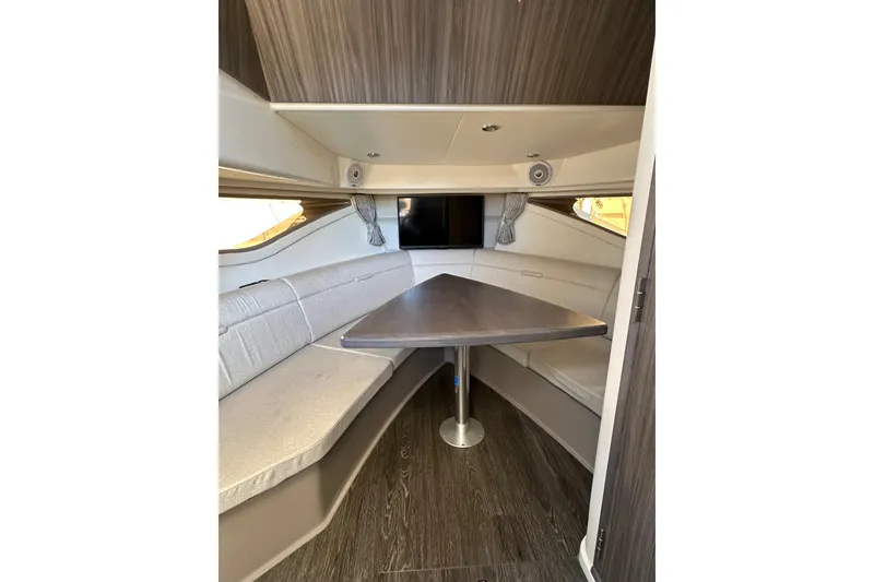 Slide: The Image of 2020 Sea Ray Sundancer 320 cabin interior with seating and table. - 7