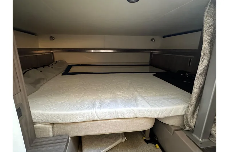 Slide: The Image of 2020 Sea Ray Sundancer 320 cabin interior with cozy bed and modern design. - 9