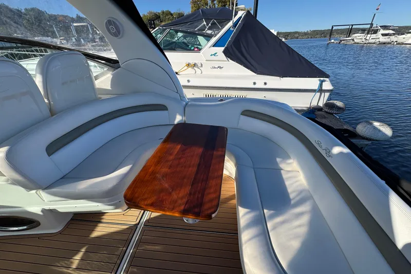 Slide: The Image of Luxurious 2007 Sea Ray 340 Sundancer boat interior with curved seating and wooden table. - 10