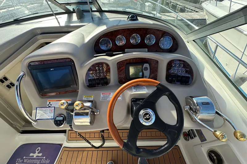 Slide: The Image of 2007 Sea Ray 340 Sundancer helm with gauges, controls, and steering wheel. - 15