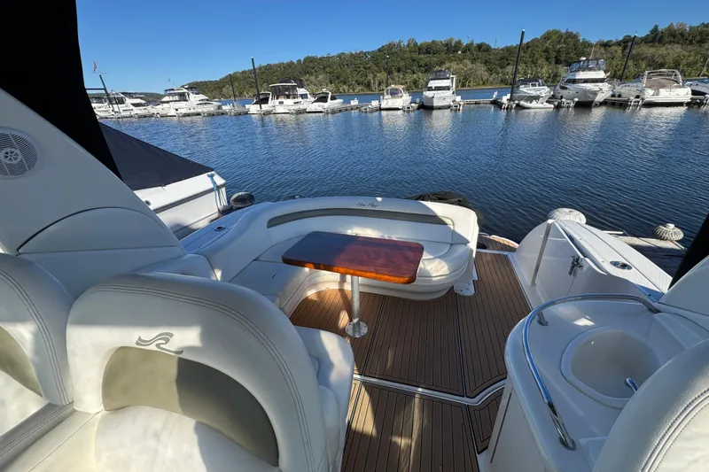 Slide: The Image of 2007 Sea Ray 340 Sundancer yacht interior with seating and table, docked at marina. - 19