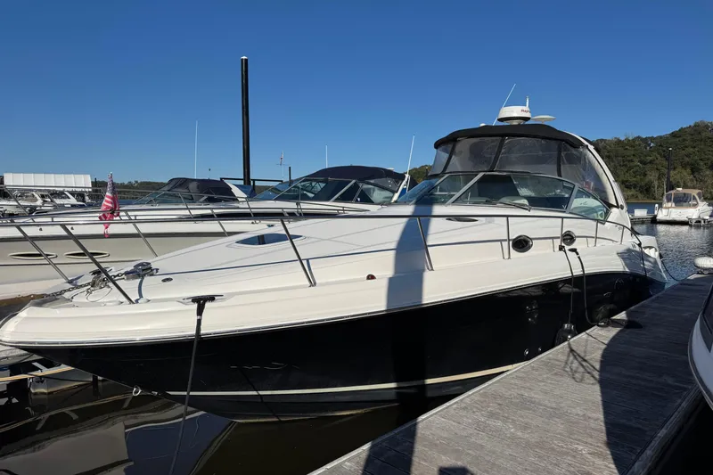 Slide: The Image of 2007 Sea Ray 340 Sundancer docked at marina under clear blue sky. - 2