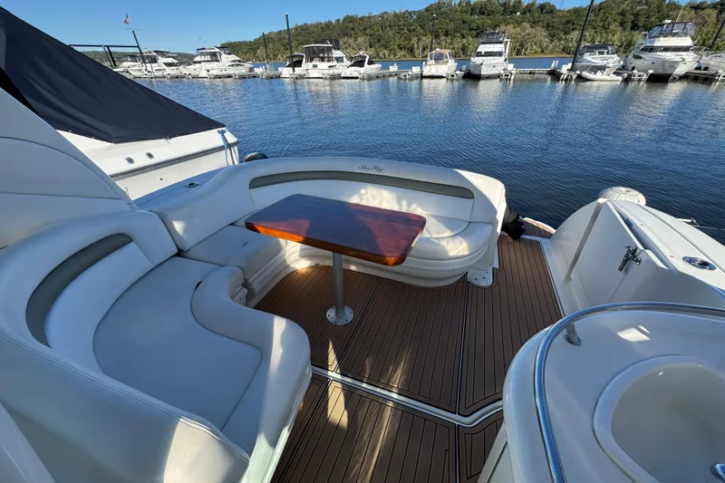 Slide: The Image of 2007 Sea Ray 340 Sundancer yacht with elegant seating and wooden table, docked at marina. - 20