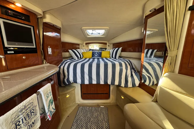 Slide: The Image of Luxurious interior of 2007 Sea Ray 340 Sundancer with striped bedding and elegant wood finishes. - 23