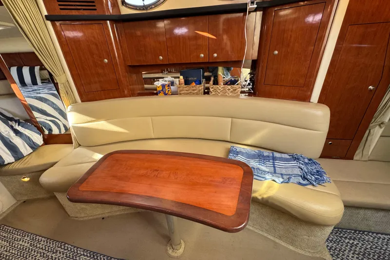 Slide: The Image of Luxurious 2007 Sea Ray 340 Sundancer cabin with elegant seating and wooden table. - 26