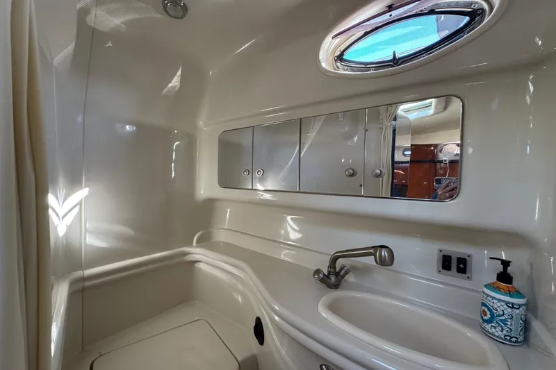 Slide: The Image of Luxurious bathroom interior of 2007 Sea Ray 340 Sundancer yacht with sink and mirror. - 31
