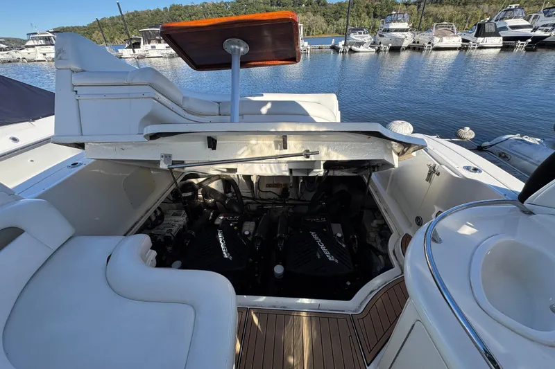 Slide: The Image of 2007 Sea Ray 340 Sundancer engine compartment open, showcasing dual Mercury engines at marina. - 32