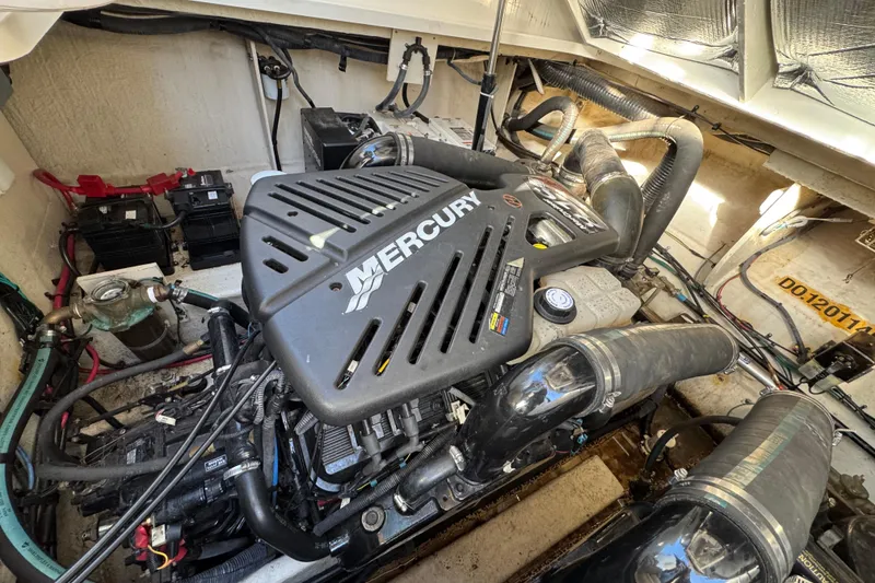 Slide: The Image of Engine compartment of 2007 Sea Ray 340 Sundancer with Mercury engine components. - 38
