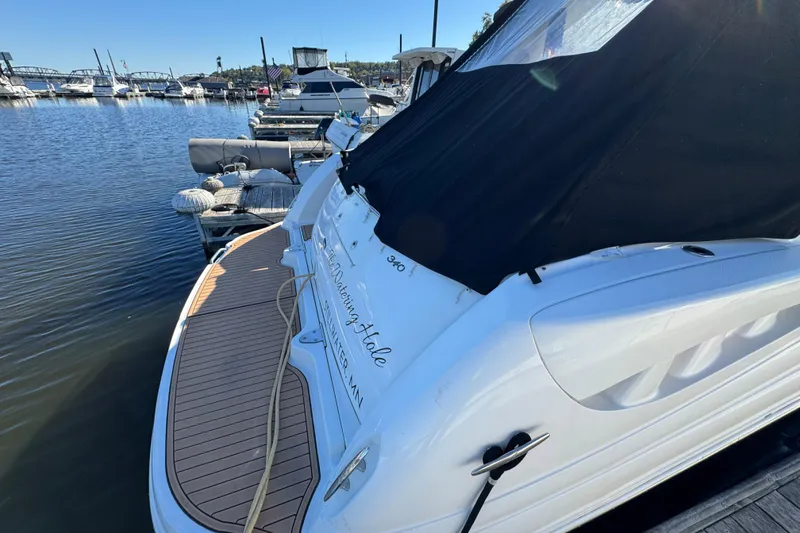 Slide: The Image of 2007 Sea Ray 340 Sundancer docked at marina, rear view with black cover. - 6