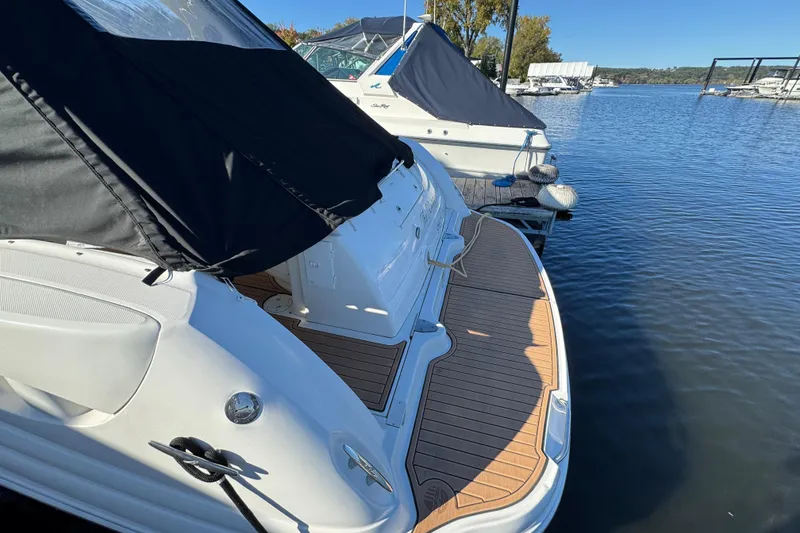 Slide: The Image of 2007 Sea Ray 340 Sundancer docked, featuring a sleek design and spacious deck. - 7