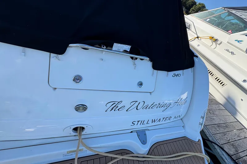 Slide: The Image of 2007 Sea Ray 340 Sundancer docked, featuring "The Watering Hole" name and Stillwater, MN location. - 8