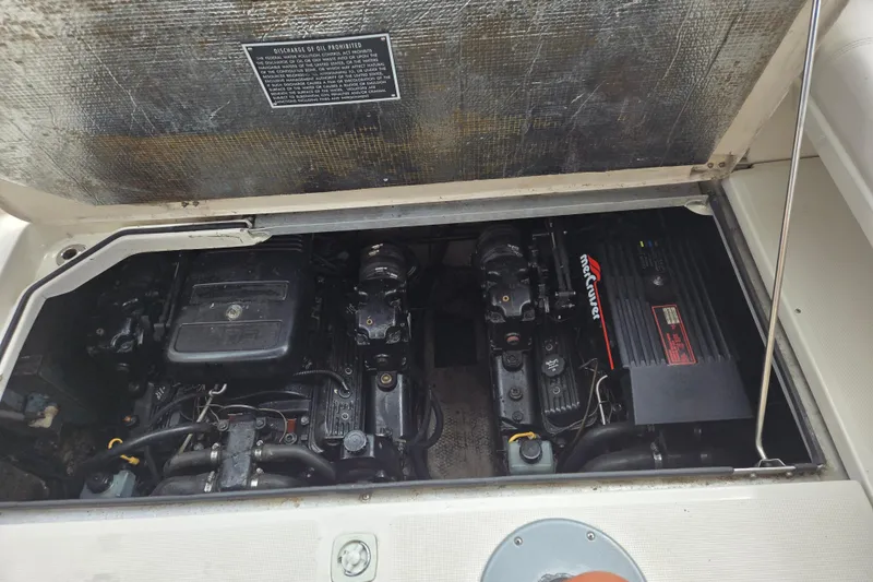 Slide: The Image of Engine compartment of a 1998 Regal Commodore 3060 boat, featuring MerCruiser engines. - 13