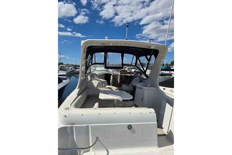 Slide: The Image of 1998 Regal Commodore 3060 boat docked under a clear blue sky. - 2