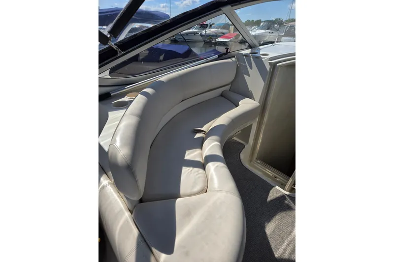 Slide: The Image of Interior of 1998 Regal Commodore 3060 boat with curved seating and cup holders. - 5