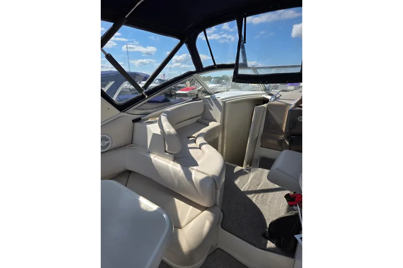 Slide: The Image of Interior of a 1998 Regal Commodore 3060 boat with beige seating and windows. - 6