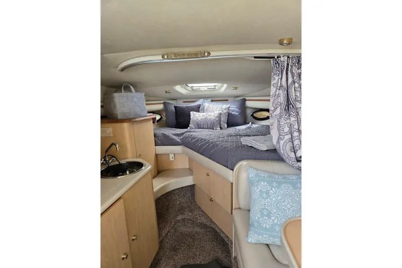 Slide: The Image of Cozy interior of a 1998 Regal Commodore 3060 boat with bed and kitchenette. - 8