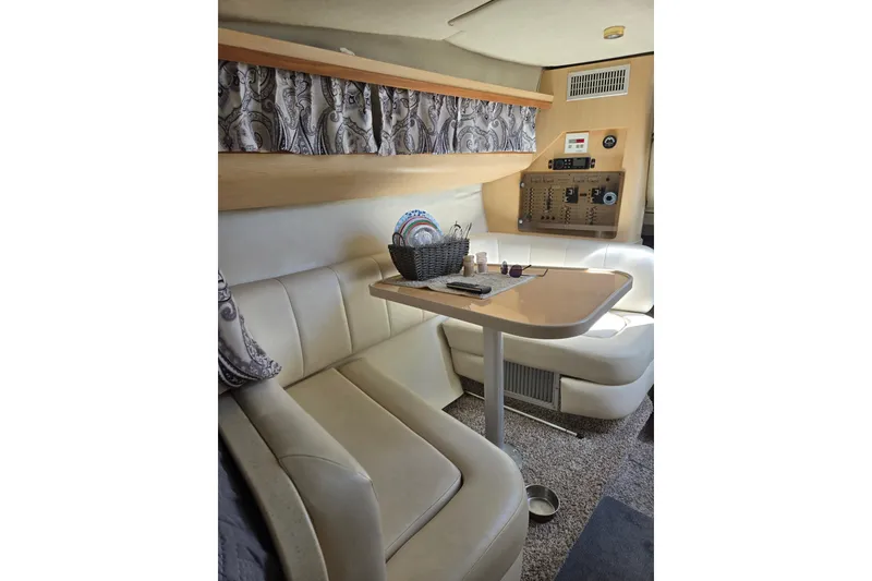 Slide: The Image of Interior of a 1998 Regal Commodore 3060 boat with seating and control panel. - 9